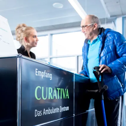 Empfangsbereich mit einem schwarzen Empfangstresen, auf dem das Wort 