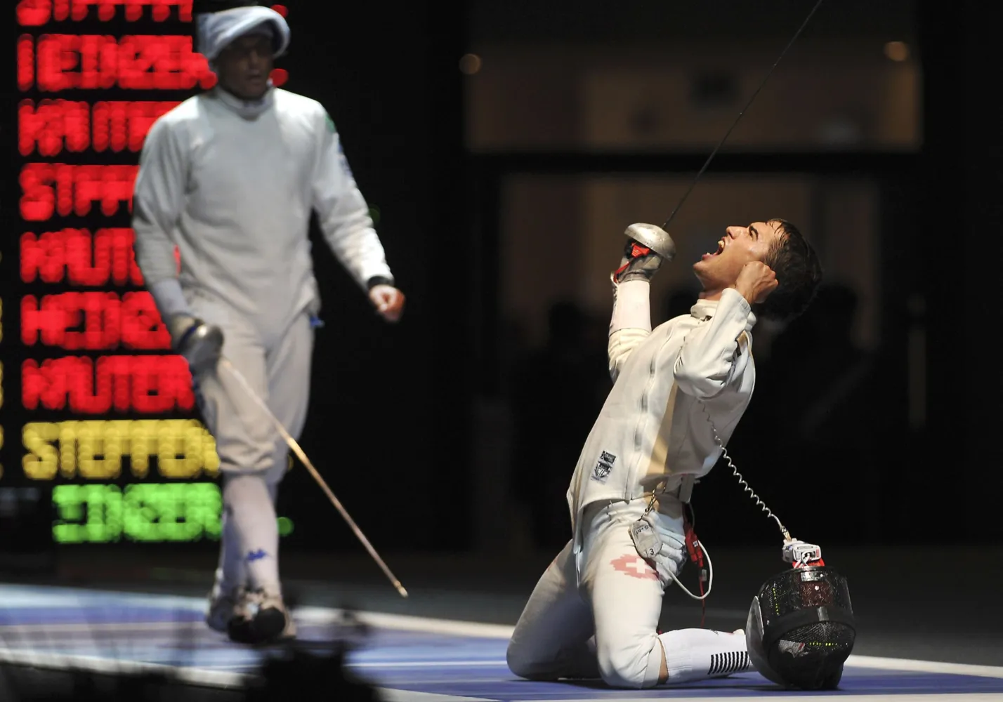 Switzerland's Max Heinzer, right, celebrates after winning a men's team epee qualifying match against Italy's Paolo Pizzo at the World Fencing Championship in Catania, Italy, Saturday, Oct. 15, 2011. (AP Photo/Carmelo Imbesi)