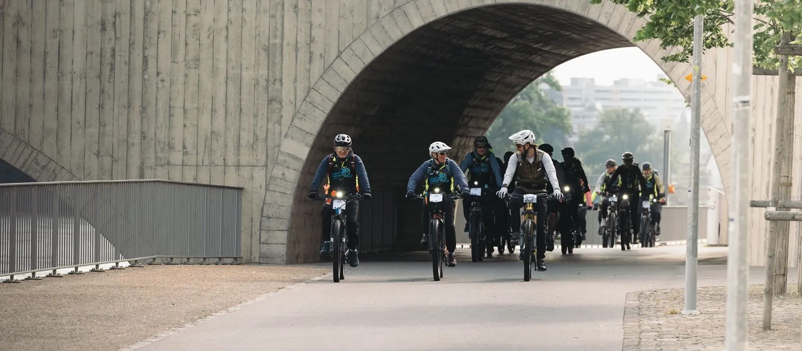 Bikegruppe unter Brückenbogen der Aarauer Kettenbrücke